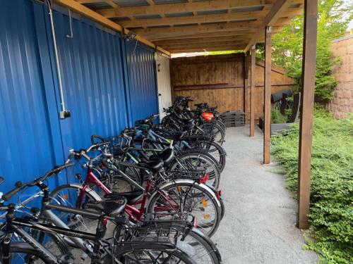 a group of bikes parked next to a blue building at Zum Alten Hafen in Rathenow