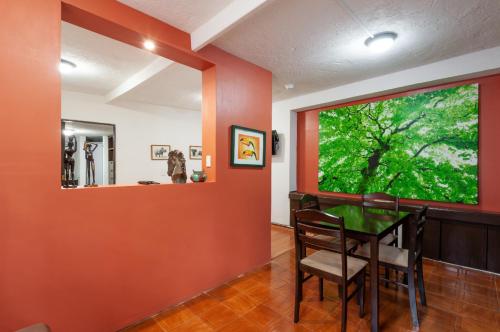 a dining room with a table and a large window at Suite 5A, Altavista, Garden House, Welcome to San Angel in Mexico City