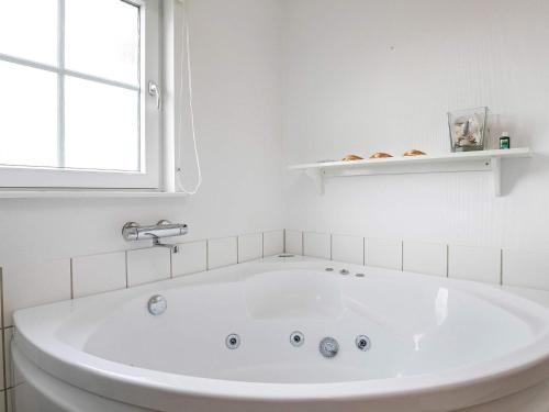 a white bath tub in a white bathroom with a window at 6 person holiday home in Brenderup Fyn in Bro