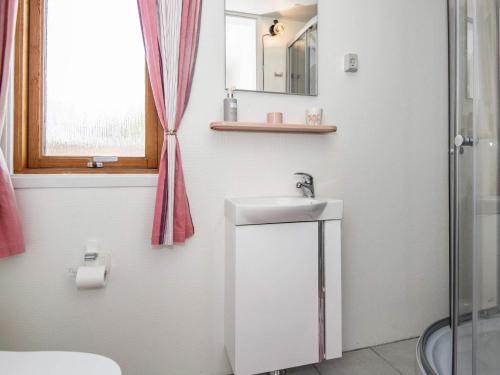 a white bathroom with a sink and a shower at Panoramic Cottage Retreat-By Traum in Hejls