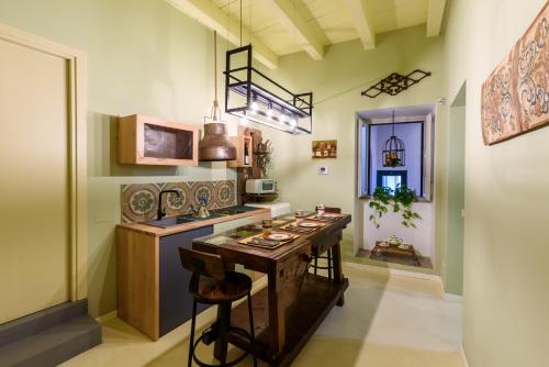 a kitchen with a island with a bar in it at CELSO 14 in Palermo