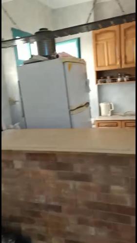 a kitchen with a white refrigerator and a counter at Cozy sunny ground chalet with terrace-Ras Sudr in Ras Sedr