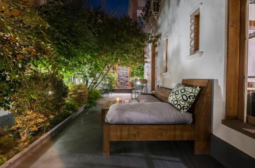 a bed sitting on a porch next to a building at Esencia Hotel Boutique in Viña del Mar