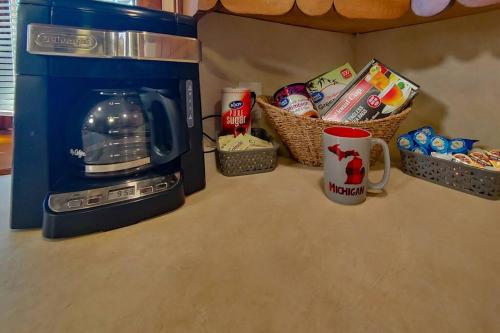 a counter top with a microwave and baskets of food at Huge historic, w/large yard & close to beach in Manistee