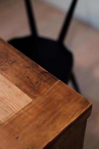 a close up of a wooden table with a black object at Plage in Yamada