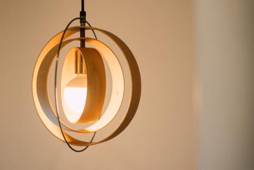 a circular light fixture hanging from a wall at Plage in Yamada