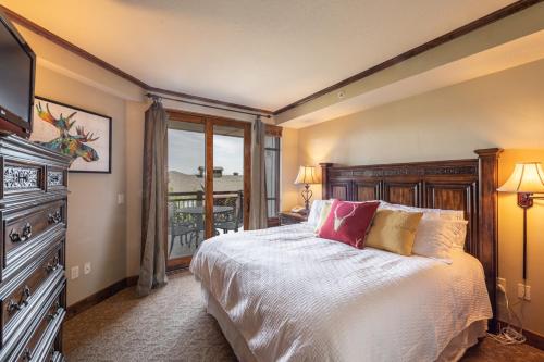 a bedroom with a bed with a television and a balcony at Luxury Resort Ski In Ski Out Hyatt Centric Residence 1BR Condo Pool Gym Hot tub Restaurant More in Park City