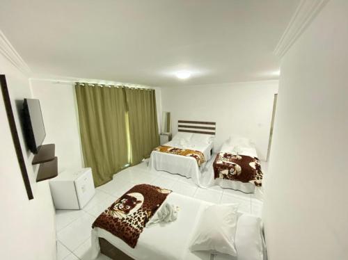 A bed or beds in a room at Pousada Verdes Mares