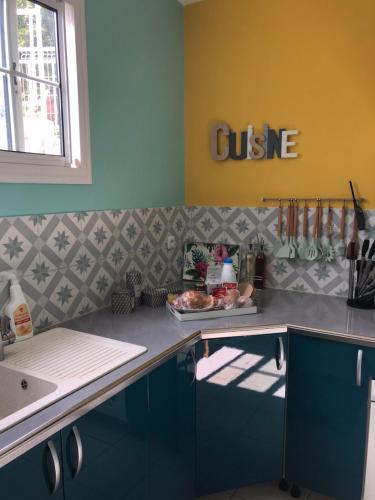 une cuisine avec des placards bleus et un comptoir dans l'établissement Villa Casa Ti Choul, à Rivière-Pilote