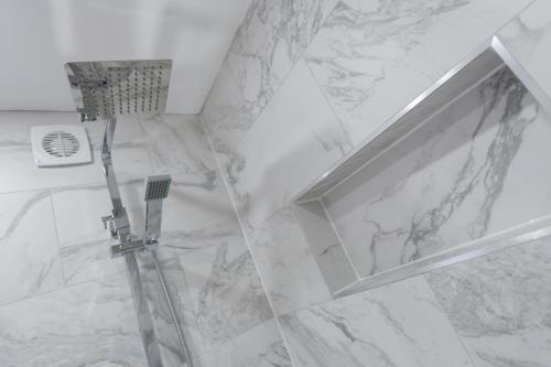 a shower with a glass door in a bathroom at Adbolton House Apartments - Sleek, Stylish, Brand New & Low Carbon in Nottingham