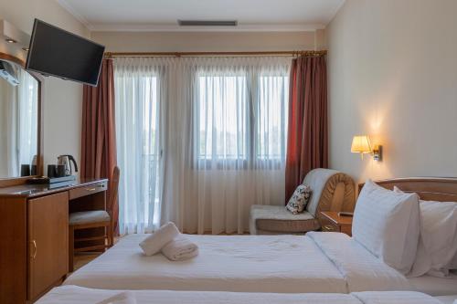 Postel nebo postele na pokoji v ubytování Xenios Dias Boutique Hotel