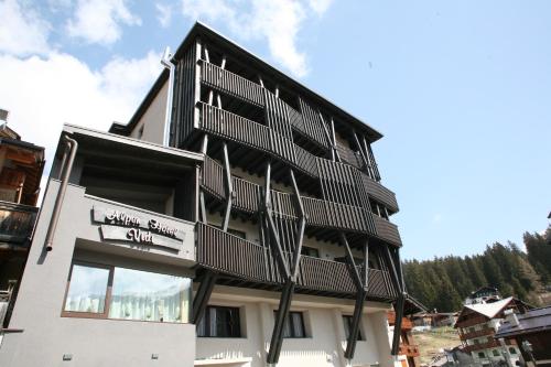 a building with balconies on the side of it at Alpen Hotel Vidi in Madonna di Campiglio