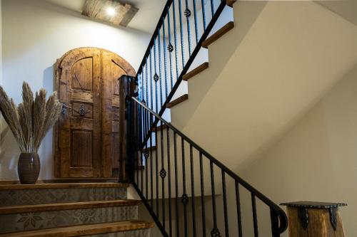 a hallway with stairs with a wooden door at House Troha - Rooms & Apartments in Bled