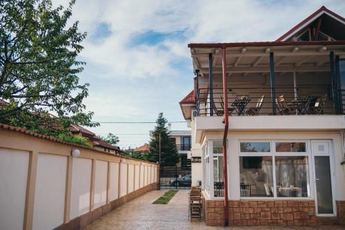 a house with a balcony on the side of it at Nest Guesthouse in Drobeta-Turnu Severin