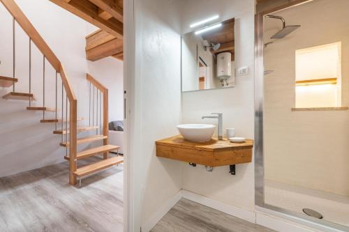a bathroom with a sink on a wooden vanity at Mary House in Carloforte