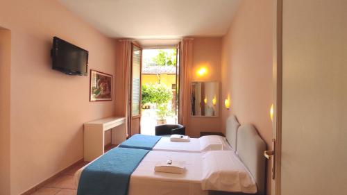Postel nebo postele na pokoji v ubytování Hotel Rita Major