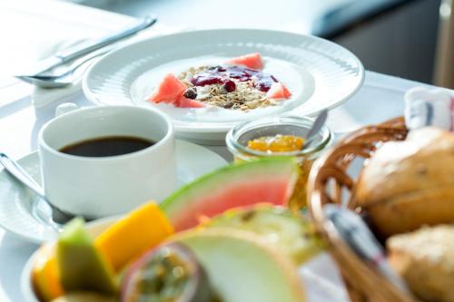 a table with two plates of food and a cup of coffee at DFDS Ferry - MiniCruise Copenhagen to Oslo in Copenhagen