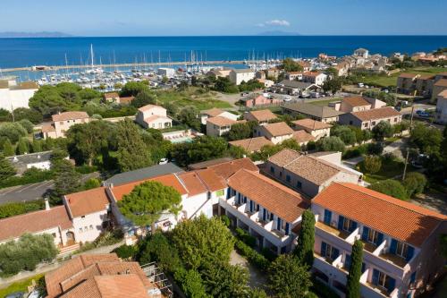 an aerial view of a town with houses and the ocean at U Libecciu in Macinaggio