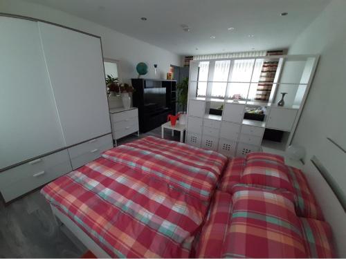 a bedroom with a bed and a tv in it at Ferienwohnung Inge in Waldsassen