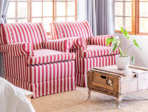 two red and white striped chairs in a bedroom at River Front Estate in Addo