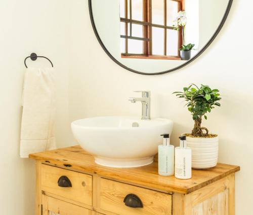 a bathroom with a sink and a mirror at River Front Estate in Addo