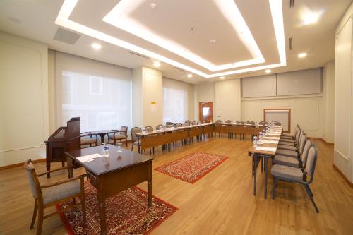 a large room with tables and chairs in it at Erboy Hotel Istanbul Sirkeci in Istanbul