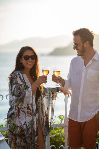 a man and a woman holding glasses of wine at Beyaz Yunus Hotel - Adult Only in Oludeniz