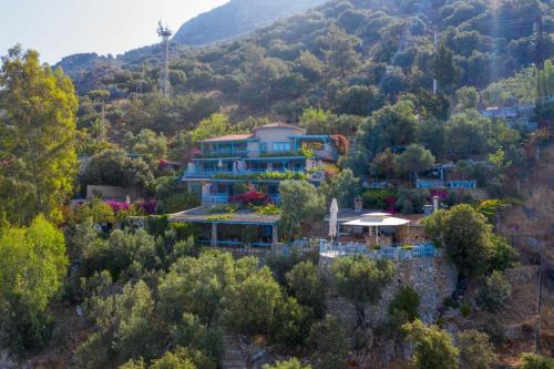 a large house in the middle of a mountain at Beyaz Yunus Hotel - Adult Only in Oludeniz