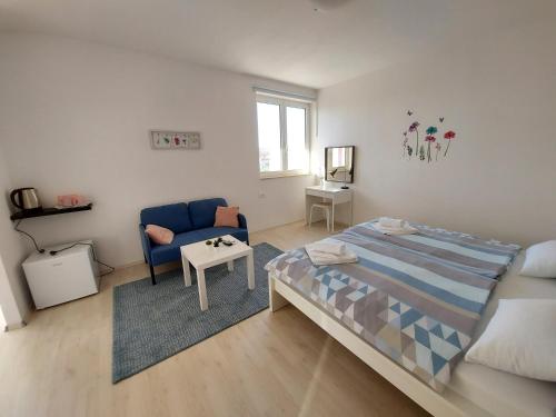 a bedroom with a bed and a chair and a table at Teta San in Motovun