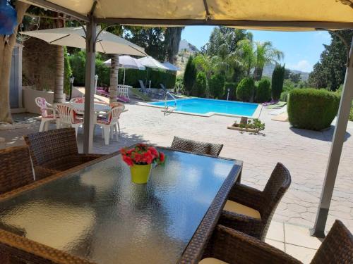 a table with a vase of flowers on top of it at Zena Holiday Villa in Pissouri
