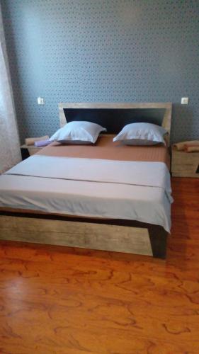 a bed with two pillows on it in a room at Pirosmani 66 in Sighnaghi