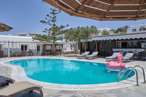 a swimming pool with a pink inflatable pool toy at Sofia Village in Mýkonos City