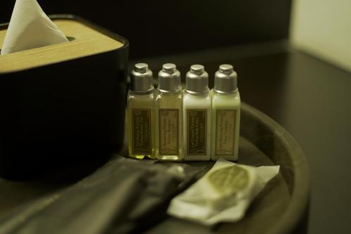 a group of four squeeze bottles sitting on a table at Awann Sewu Boutique Hotel and Suite Semarang in Semarang