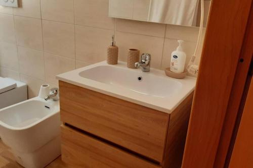 a bathroom with a sink and a toilet at MaMa house in Le Castella