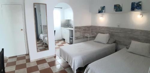 Postel nebo postele na pokoji v ubytování Hostal Nevada