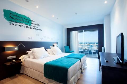 a hotel room with a large bed and a television at Hotel Costa Azul in Palma de Mallorca