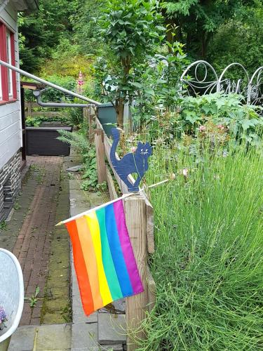 a colorful towel on a fence with a cat on it at Frauenpension Arleta - Women only in Goslar
