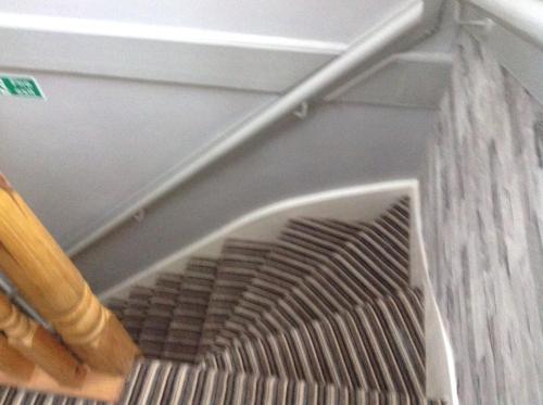 an empty stairwell in a room with a metal railing at Sherwood Lodge in Skegness