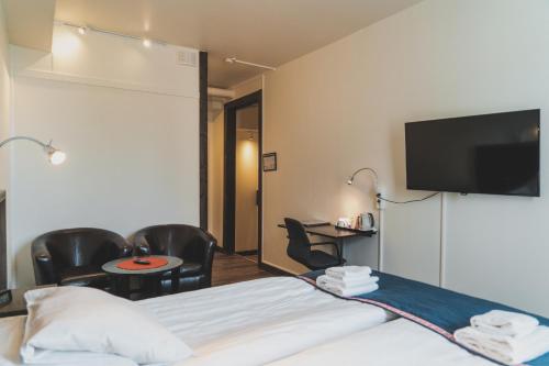 a hotel room with a bed and a flat screen tv at Best Western Hotel Arctic Eden in Kiruna