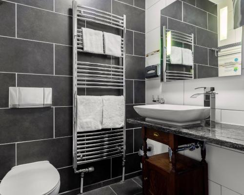 a bathroom with a sink and a toilet at Villa Salve in Binz