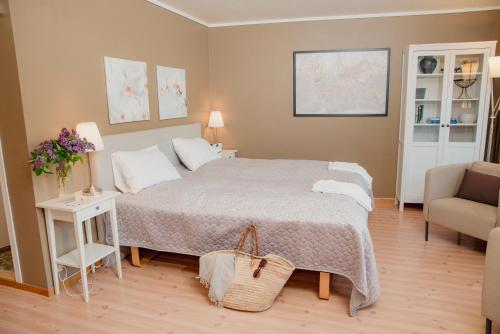 a bedroom with a bed and a couch and a chair at Åkrafjordtunet Apartments in Teigland