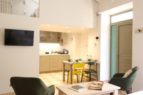 a kitchen and dining room with a table and chairs at For4 Seasons Home 2 - by Avelink in Spáta