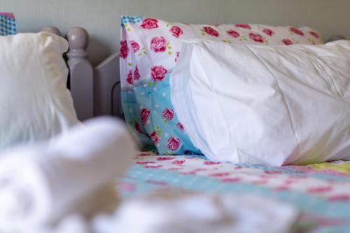 a bed with two pillows and a blanket at Lambrini Studios in Parga