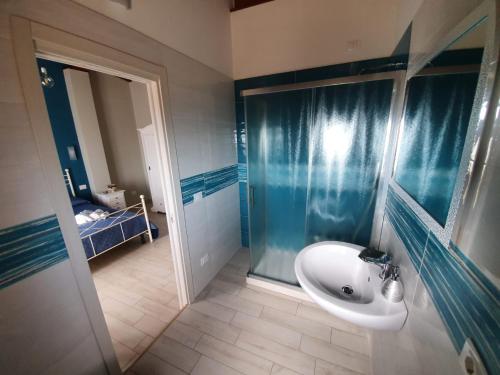 a bathroom with a sink and a glass shower at Colle Del Mirto in Castelnuovo Cilento