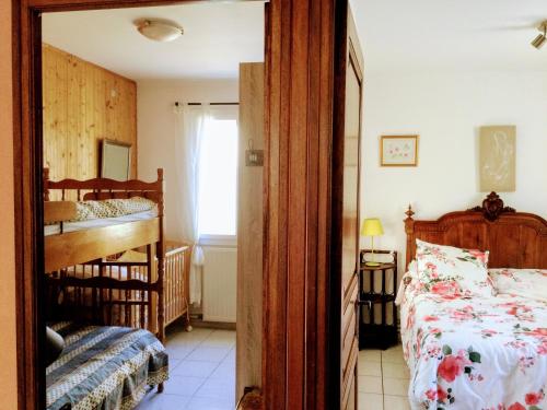 a bedroom with a bed and a crib in it at le vieux pont in Carpentras