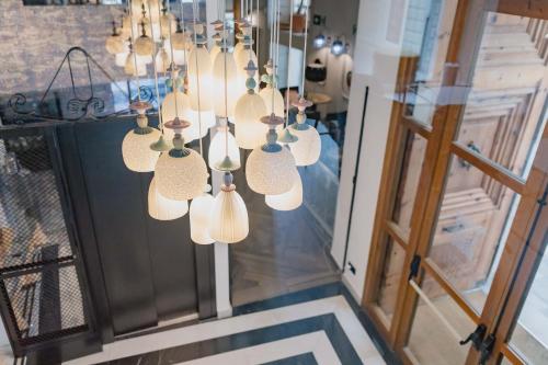 a bunch of chandeliers hanging in a store at MYR Marqués House in Valencia