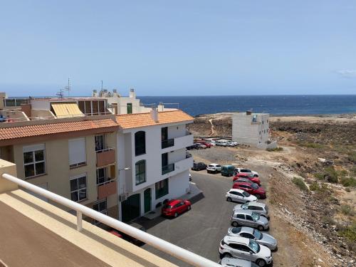 a group of cars parked in a parking lot near the ocean at Angel House in Los Abrigos