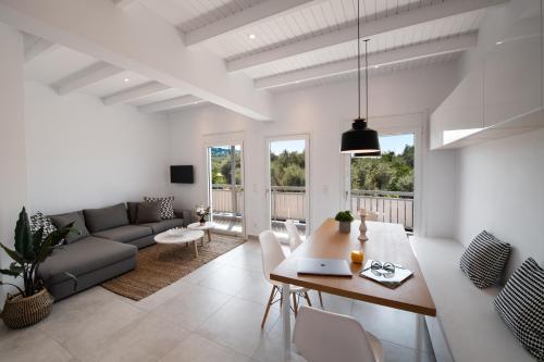 a living room with a table and a couch at Summer Vibes Tsoukalades in Tsoukaladhes
