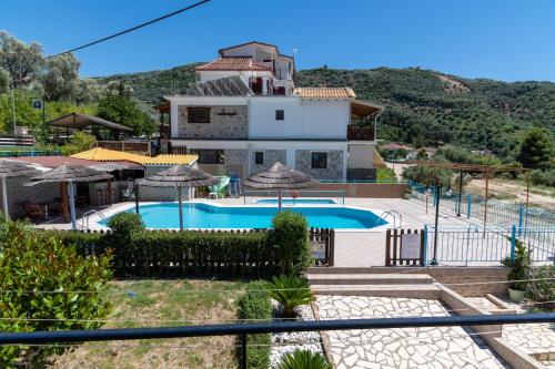 a villa with a swimming pool and a house at Lambrini Studios in Parga