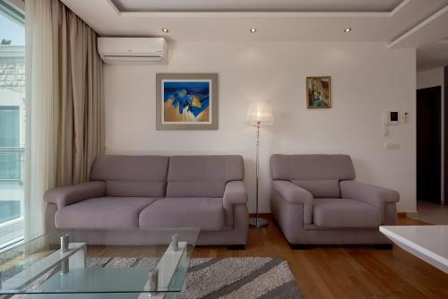a living room with a couch and a table at BigMontenegro Dreams in Becici